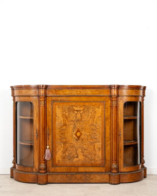 fig 1. An antique Victorian burr walnut credenza featuring a central inlaid marquetry door flanked by two curved glazed display cabinets and gilt mounts.