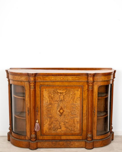 fig 2. An antique Victorian burr walnut credenza featuring a central inlaid marquetry door flanked by two curved glazed display cabinets and gilt mounts.
