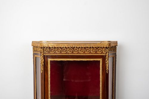 fig 4. An antique French mahogany vitrine display cabinet featuring hand-painted Vernis Martin panels, gilt bronze mounts, cabriole legs, and a red velvet interior.