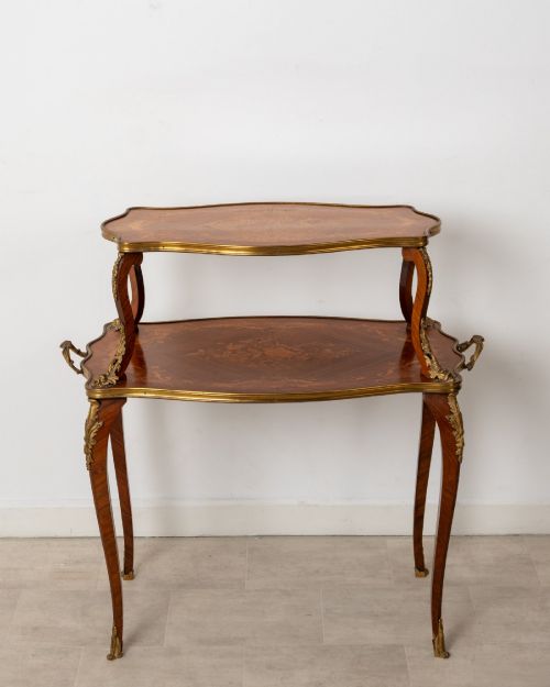 fig 1. An antique Louis XV style two-tier kingwood side table featuring floral marquetry inlay, serpentine edges, and gilt-bronze mounts on cabriole legs.