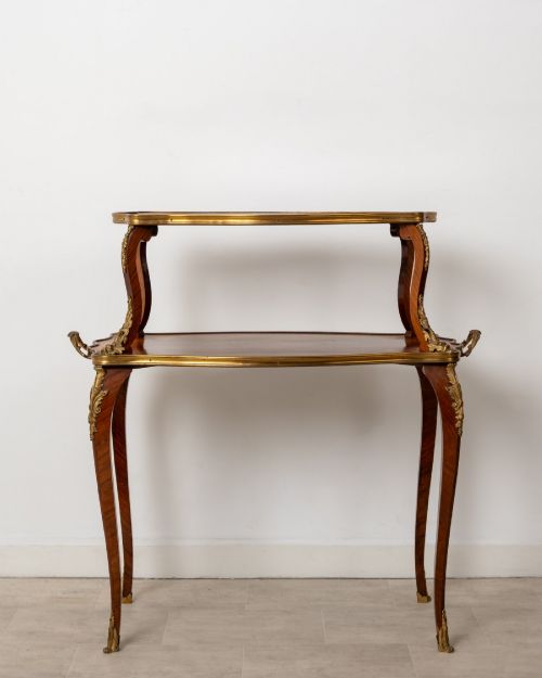 fig 2. An antique Louis XV style two-tier kingwood side table featuring floral marquetry inlay, serpentine edges, and gilt-bronze mounts on cabriole legs.