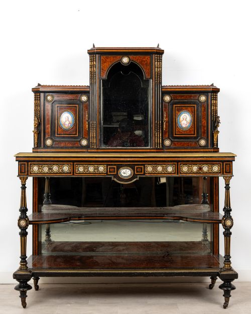 fig 1. A nineteenth-century French ebonised and amboyna bonheur du jour desk featuring porcelain plaques, mirrored panels, turned legs, and brass mounts.