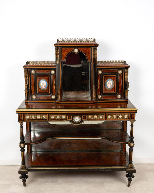 fig 2. A nineteenth-century French ebonised and amboyna bonheur du jour desk featuring porcelain plaques, mirrored panels, turned legs, and brass mounts.