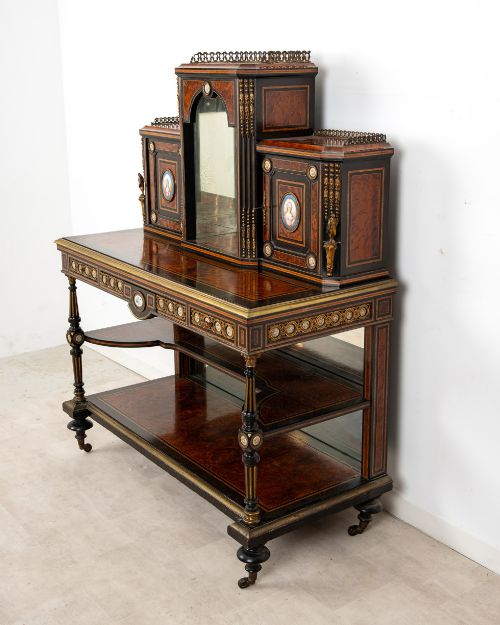 fig 3. A nineteenth-century French ebonised and amboyna bonheur du jour desk featuring porcelain plaques, mirrored panels, turned legs, and brass mounts.