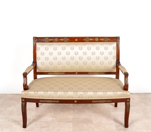fig 3. A three-piece antique French Empire Revival salon suite comprising a mahogany two-seater settee and two matching side chairs with gold silk laurel wreath upholstery and ormolu mounts.