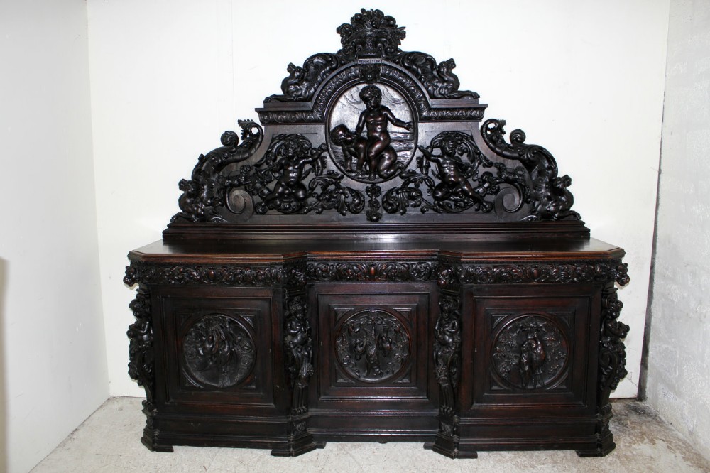 A LARGE CARVED OAK SIDEBOARD
