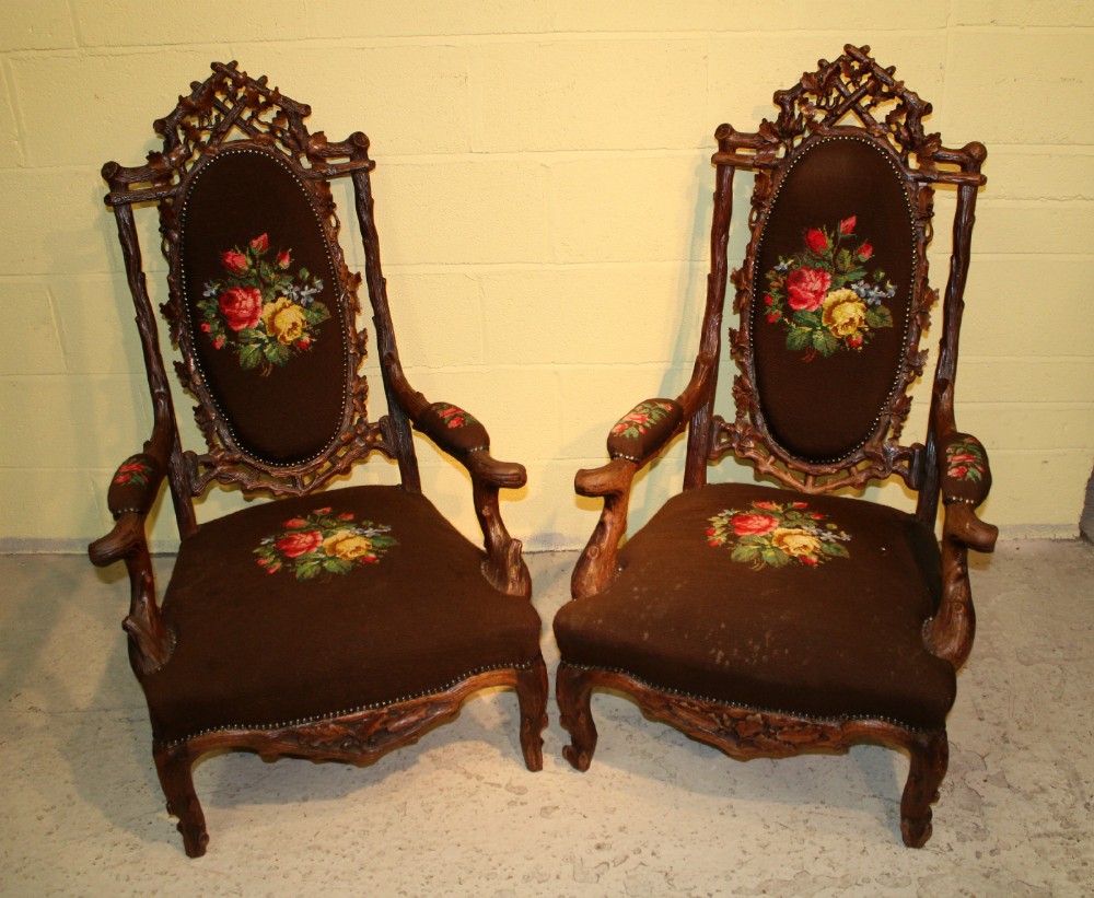 A PAIR OF CARVED BLACK FOREST ARMCHAIRS