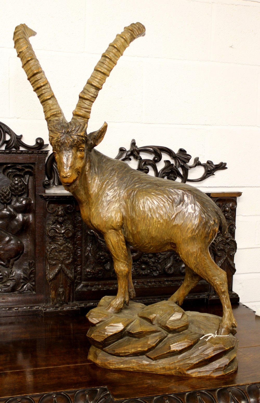 A LARGE CARVED BLACK FOREST FIGURE OF IBEX