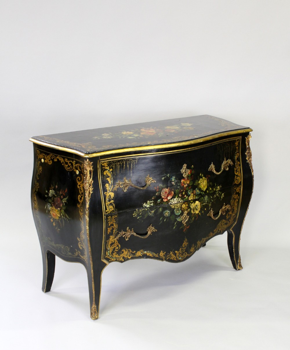 A DECORATIVE EBONIZED FRENCH SERPENTINE FRONTED COMMODE