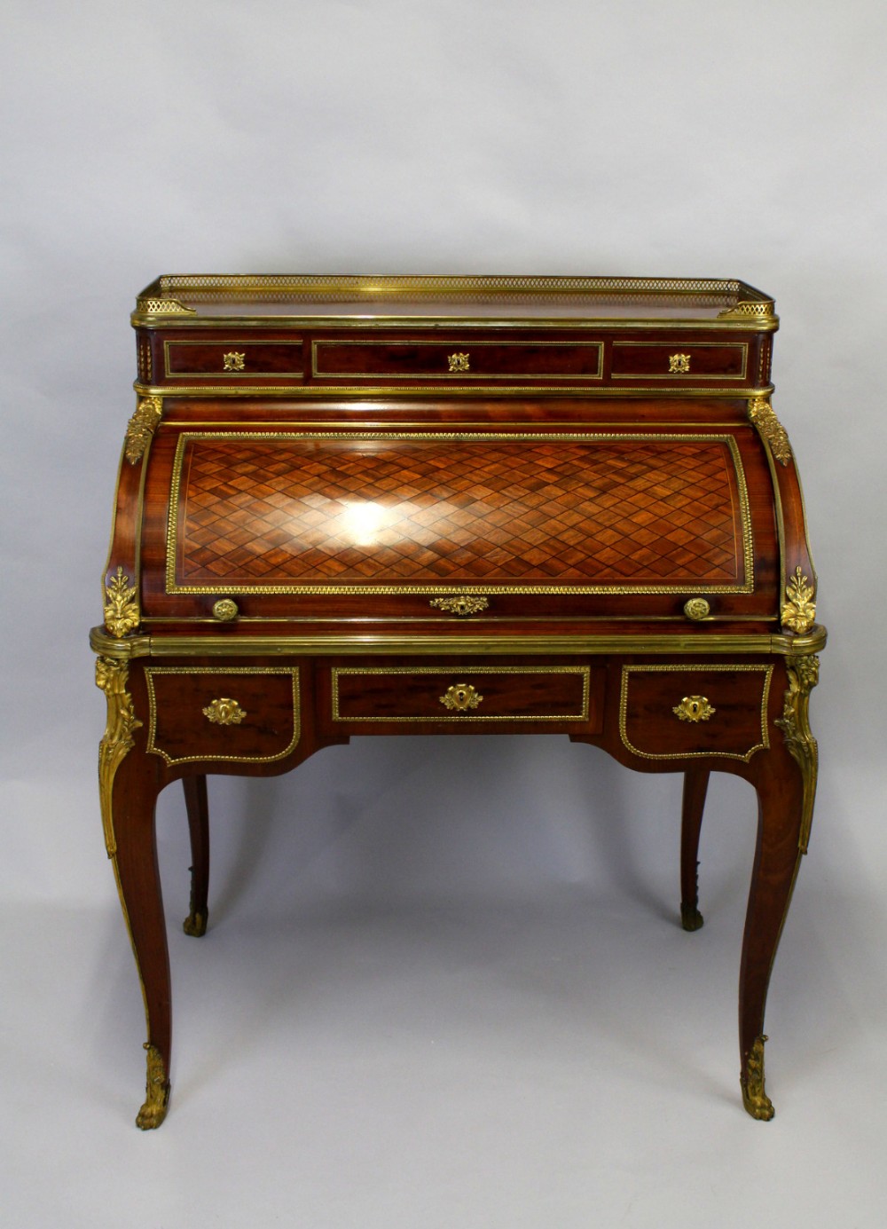 AN EXHIBITION QUALITY FRENCH MAHOGANY & PARQUETRY GILT BRONZE CYLINDER DESK