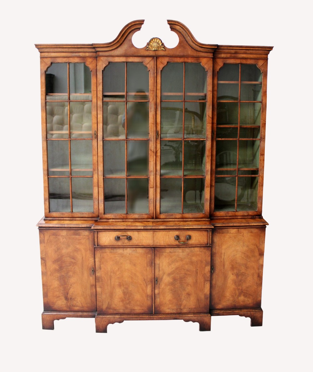 A BEAUTIFUL WALNUT BREAKFRONT BOOKCASE IN THE GEORGIAN MANNER