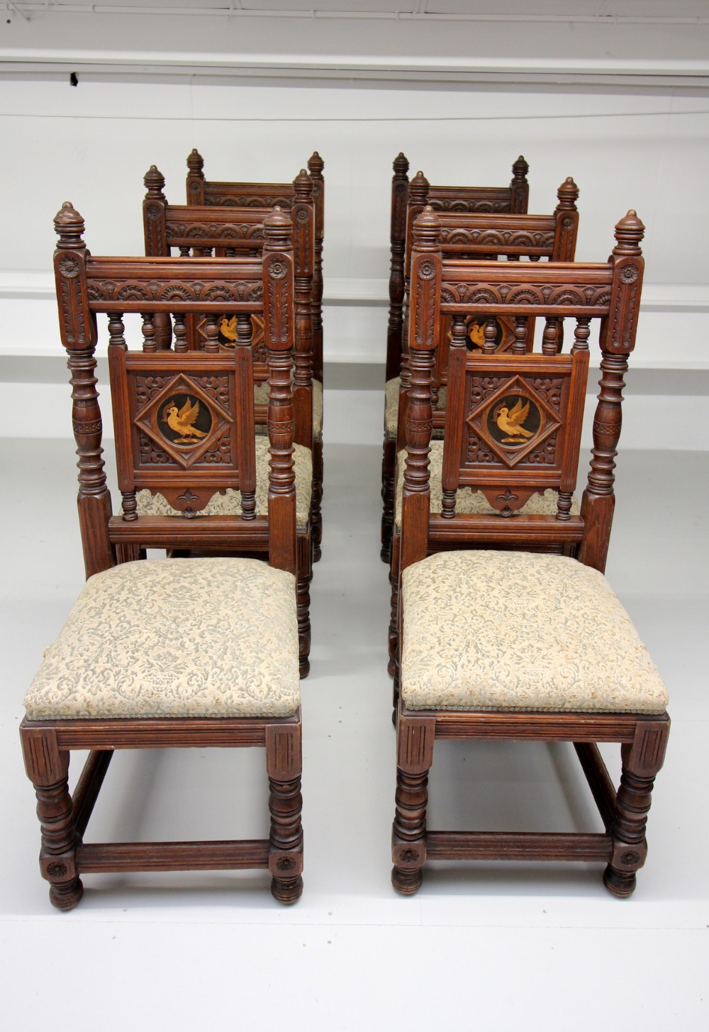 A SET OF 6 CARVED OAK CHAIRS STAMPED GILLOW DESIGNED BY BRUCE TALBERT 