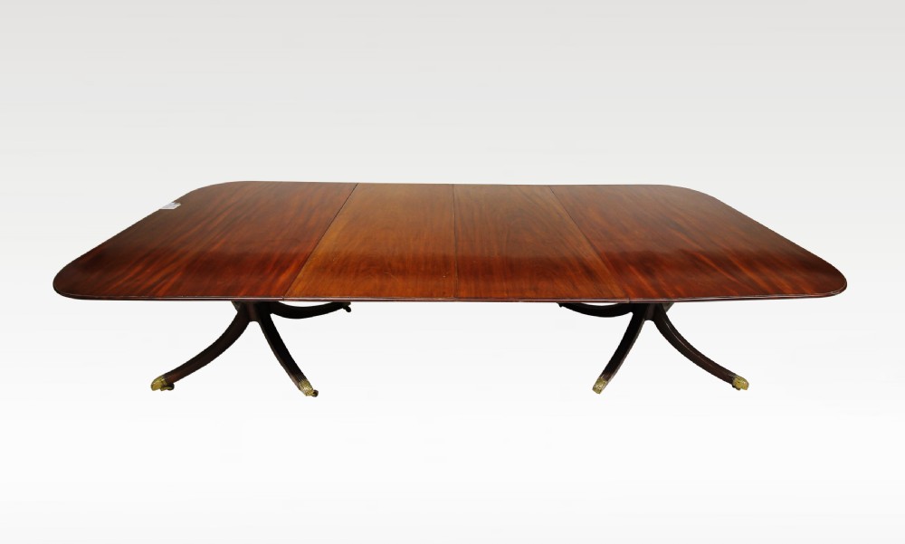 A MAHOGANY TWIN PILLAR DINING TABLE WITH TWO EXTRA LEAFS 
