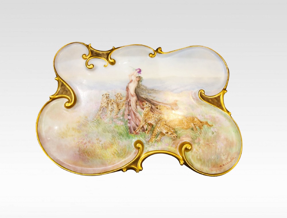 A PORCELAIN PLAQUE OF SCROLLING FORM STAMPED A H LANGTON