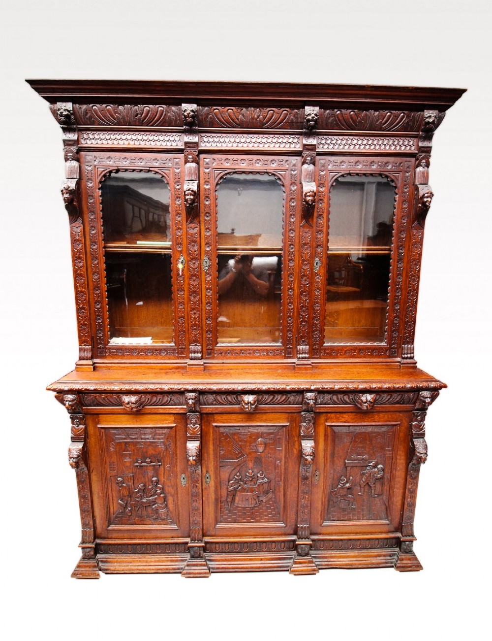 19TH CENTURY CARVED OAK THREE DOOR BOOKCASE