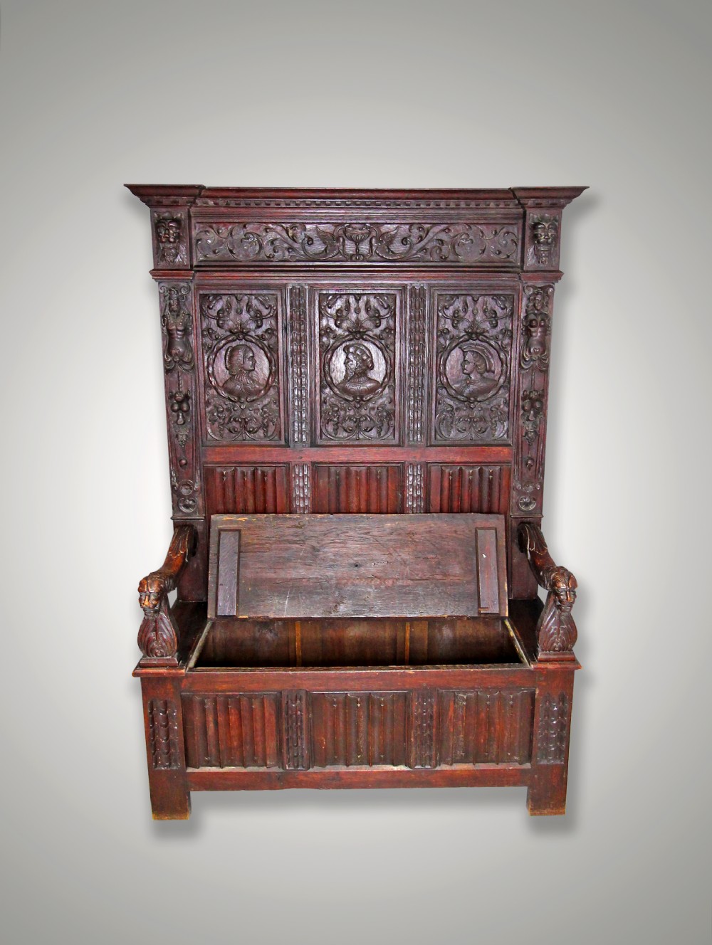 A CARVED OAK HALL BENCH