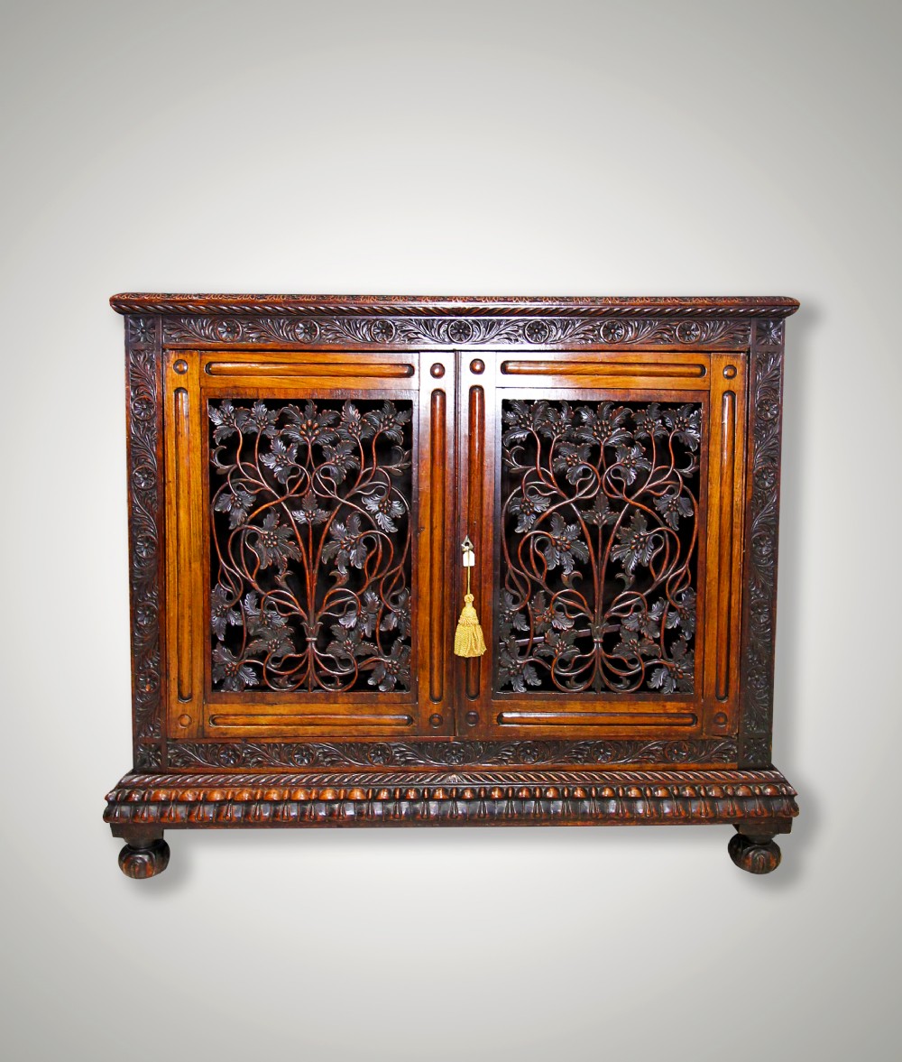 A CARVED OAK COLONIAL TWO DOOR SIDE CABINET