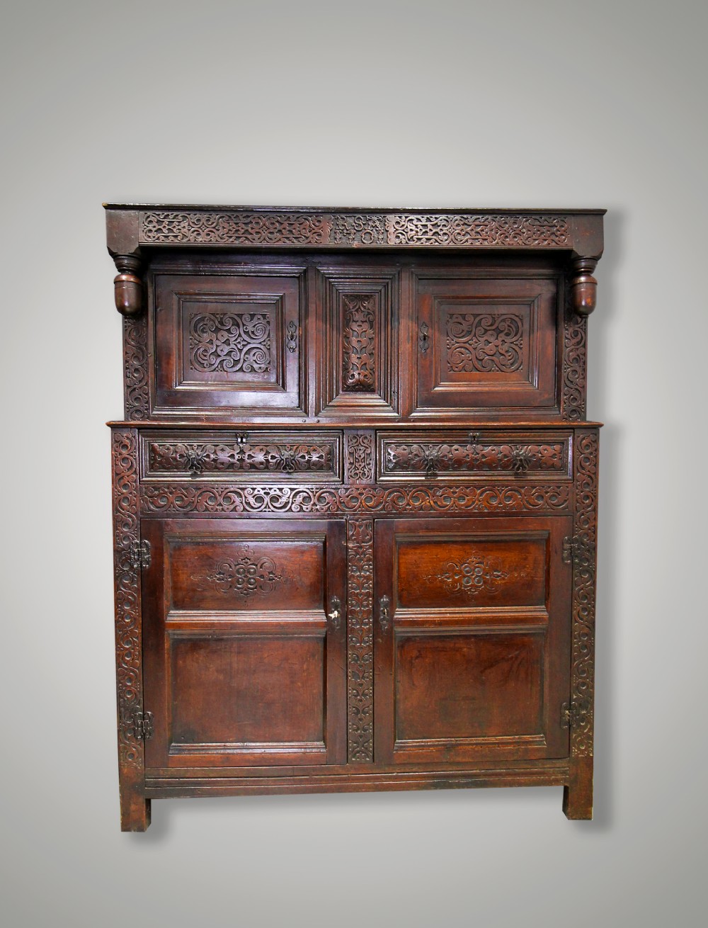 A WILLIAM III CARVED OAK PRESS CUPBOARD