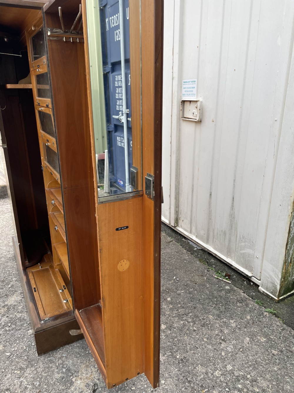 An Art Deco two-door compactum wardrobe crafted from book-matched burr walnut veneer with central keyholes and a solid plinth base. View VII