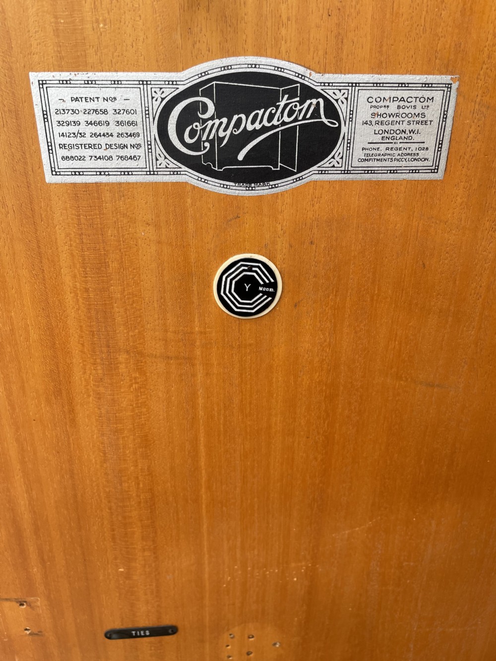An Art Deco two-door compactum wardrobe crafted from book-matched burr walnut veneer with central keyholes and a solid plinth base. View VIII