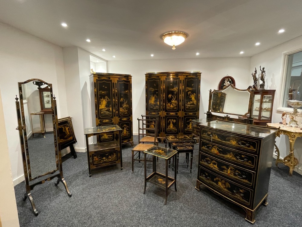 A stunning 11 piece black lacquered chinoiserie bedroom suite 
