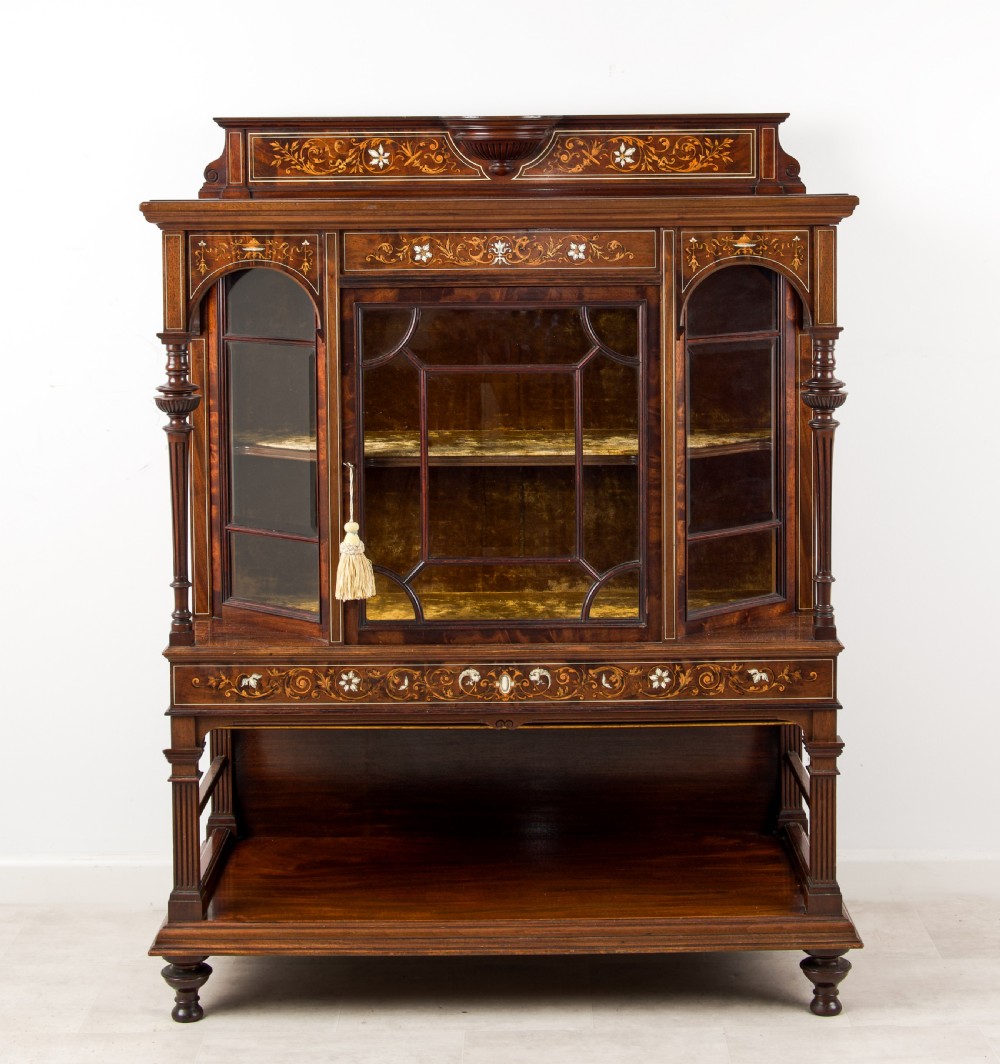 A Victorian dark brown timber display cabinet featuring intricate floral marquetry inlay, glazed central doors with geometric glazing bars, and an open lower shelf. View II