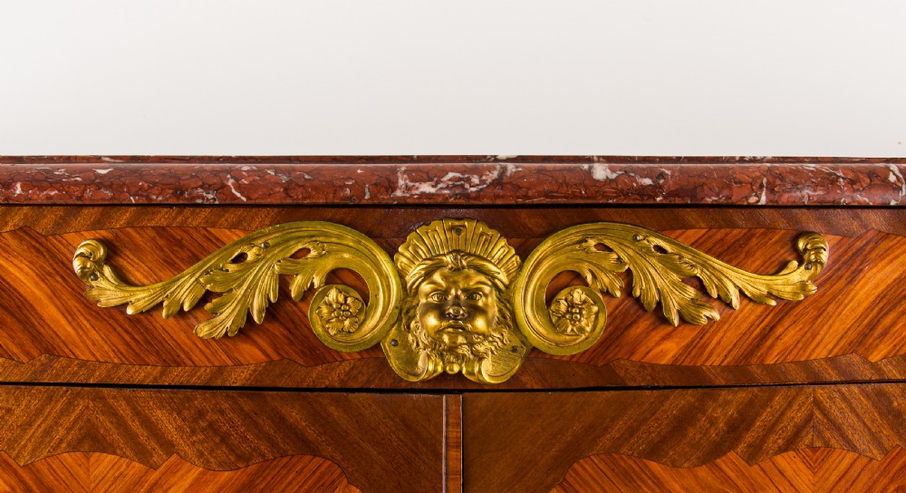 A 19th-century French kingwood side cabinet featuring geometric parquetry doors, gilt bronze mounts, and a marble top. View IV