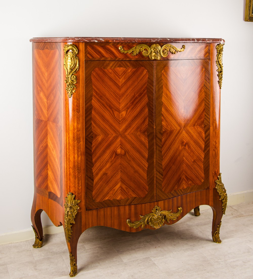 A 19th-century French kingwood side cabinet featuring geometric parquetry doors, gilt bronze mounts, and a marble top. View VII