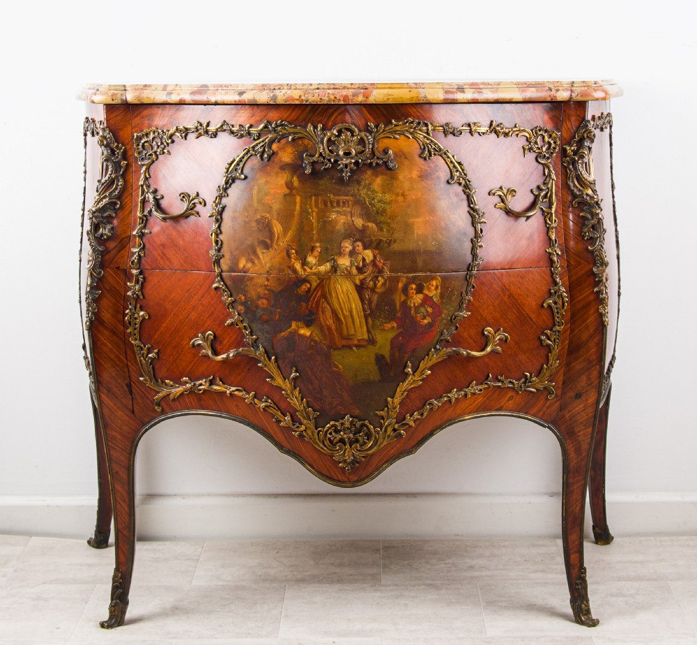 An antique French Louis XV style bombe commode featuring a hand-painted Vernis Martin figurative scene, ornate gilt-bronze mounts, and a shaped breccia marble top.