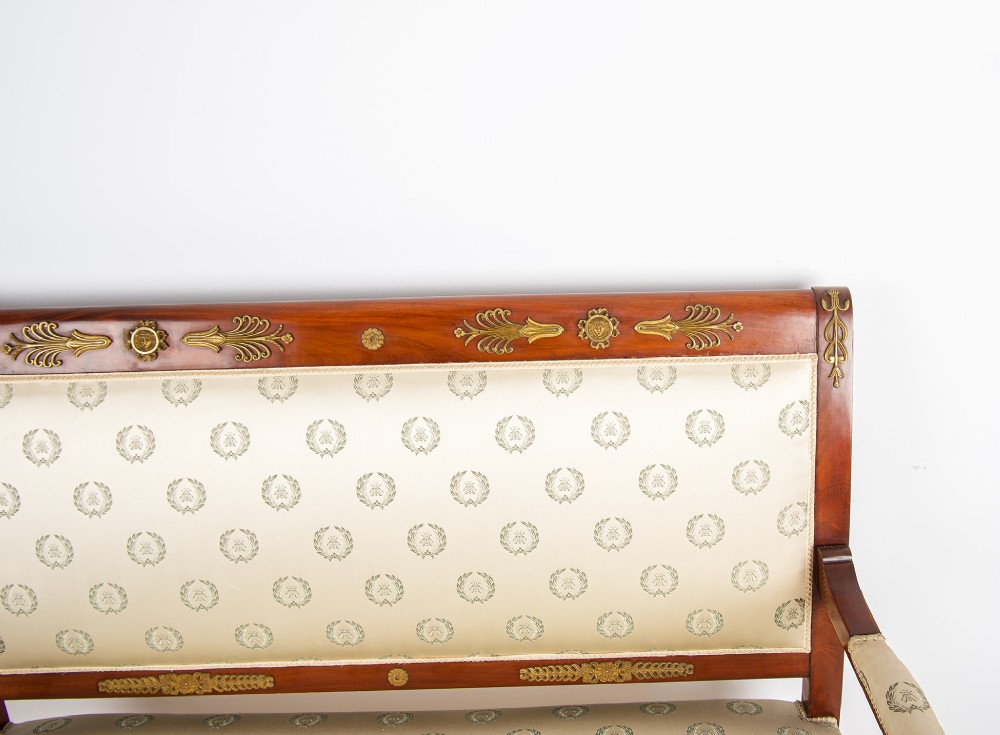 A French Empire Revival mahogany settee with cream patterned silk upholstery, curved arms, and gilded metal ormolu mounts. View III