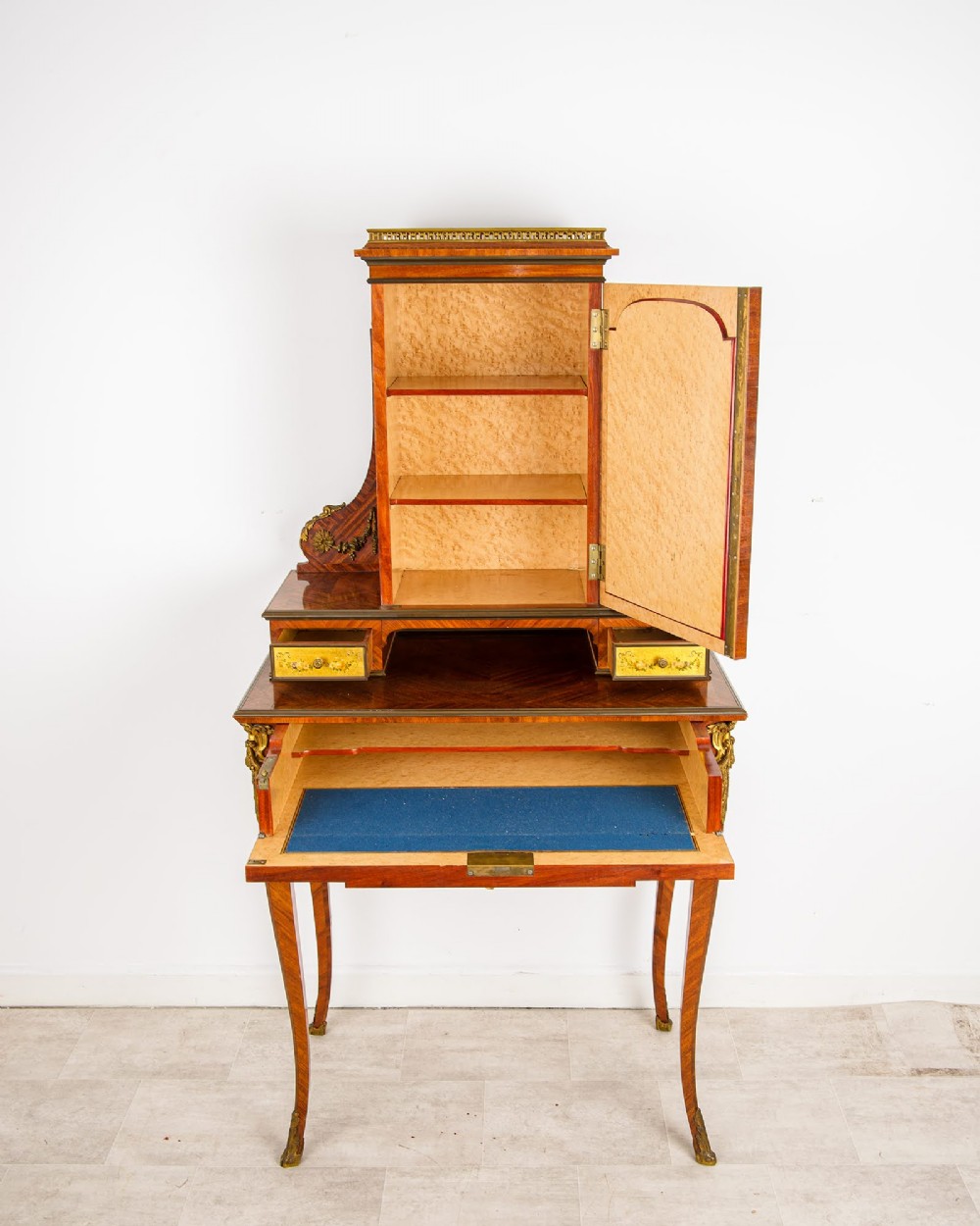 A nineteenth-century French kingwood writing cabinet featuring slender cabriole legs, gilt-bronze mounts, and a central Vernis Martin painted panel depicting a pastoral scene. View III