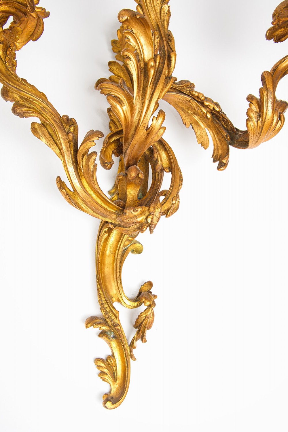 A pair of gilt bronze French ormolu three-branch wall lights decorated with sweeping Rococo acanthus leaf scrollwork. View VIII