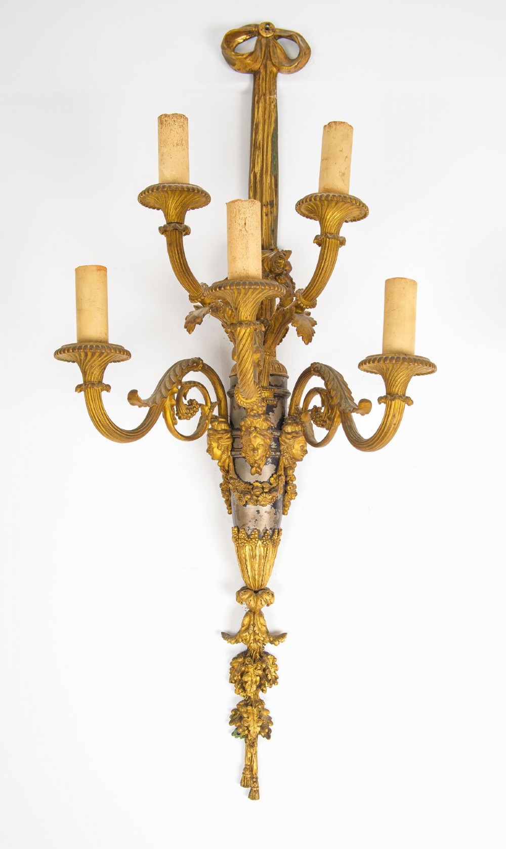 A pair of French Louis XVI style gilt-bronze five-light wall sconces featuring ribbon bow tops, leaf motifs, and classical mask details. View II