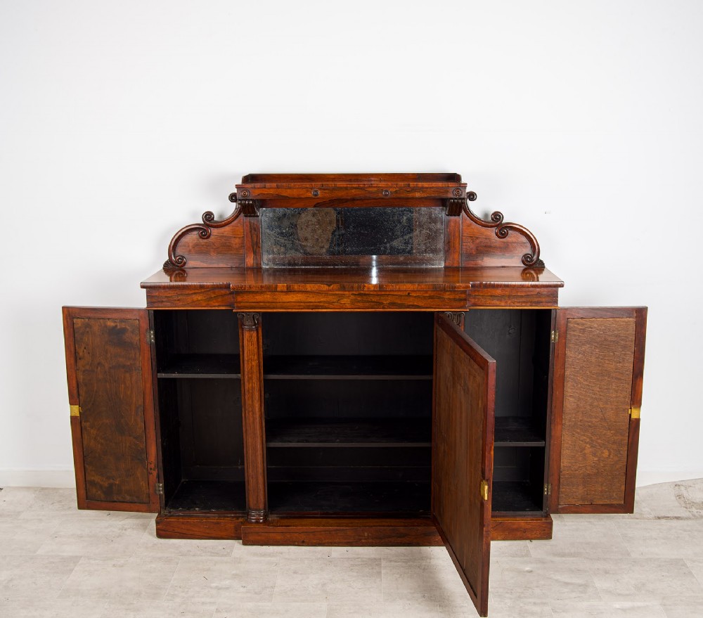 A Victorian rosewood side cabinet featuring a scroll-carved upper back with a shelf and mirror, positioned above three glass-panelled cupboard doors. View VIII