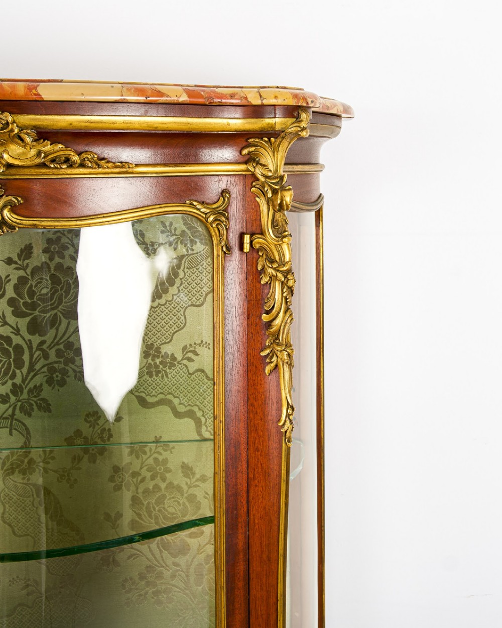 An antique French Louis XV style vitrine cabinet featuring a marble top, glass panels, a fabric-lined interior with glass shelves, and gilt bronze mounts throughout. View V