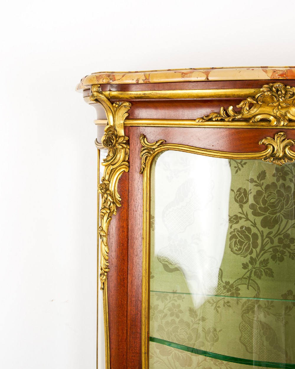 An antique French Louis XV style vitrine cabinet featuring a marble top, glass panels, a fabric-lined interior with glass shelves, and gilt bronze mounts throughout. View VIII