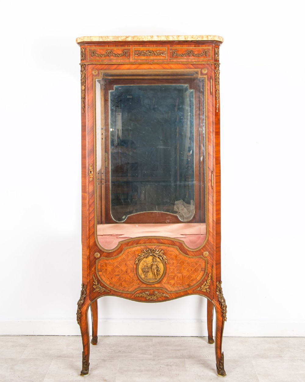 An antique French kingwood vitrine cabinet featuring ornate ormolu mounts, a glazed door with a mirrored interior back, and a contoured marble top resting on slender cabriole legs. View II
