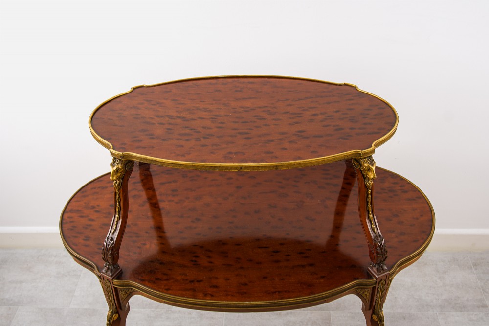 A two-tier French mahogany etagere centre table featuring oval surfaces, slender cabriole legs, and ornate gilded ormolu mounts. View V