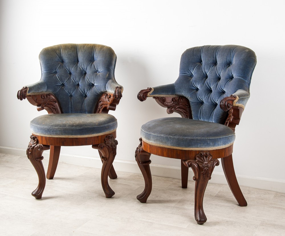 A pair of Victorian carved mahogany armchairs with button-backed blue velvet upholstery and detailed carved legs. View III