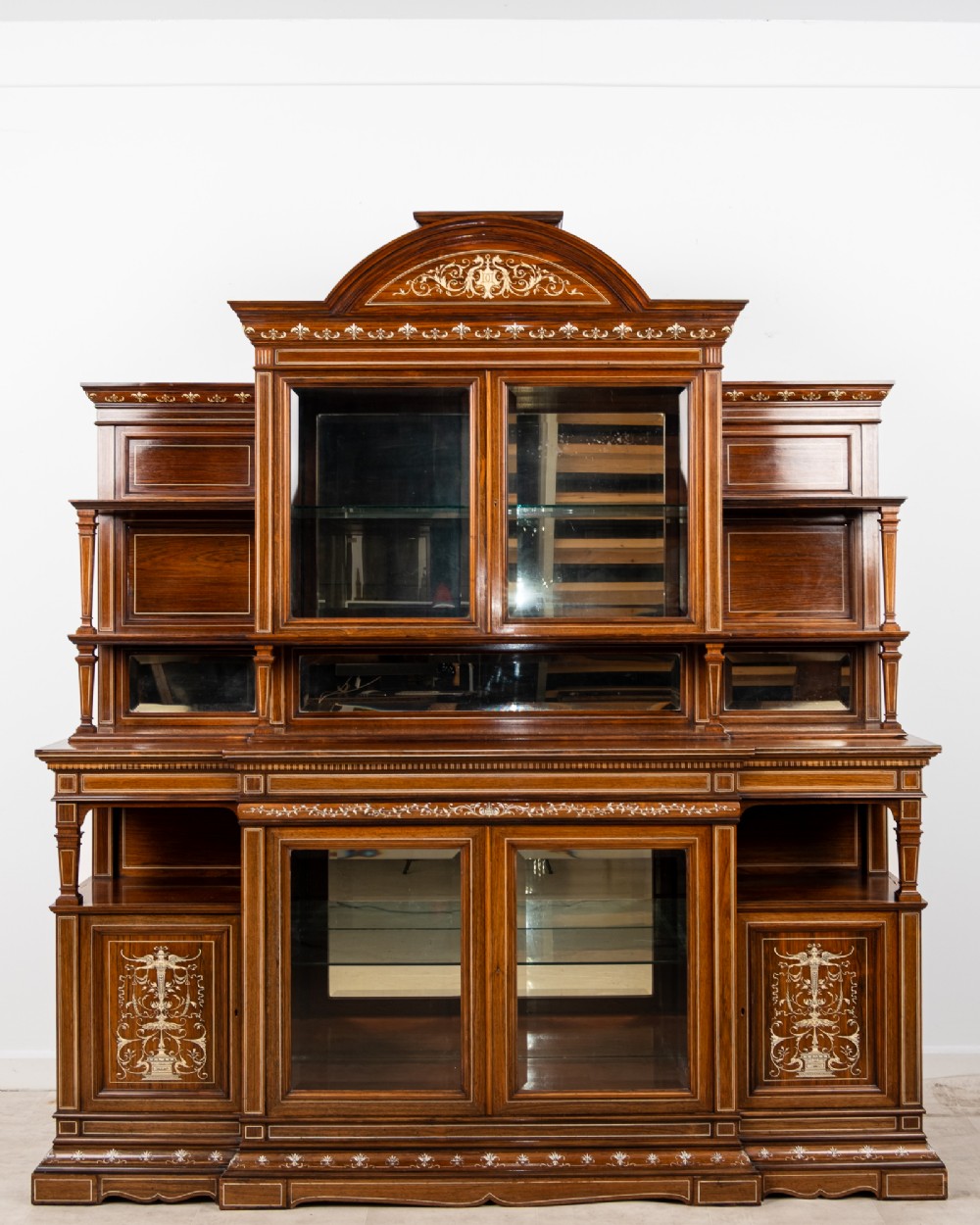 A monumental Victorian rosewood display cabinet featuring marquetry inlay, glazed doors, mirrored panels, and multi-tiered shelving. View II