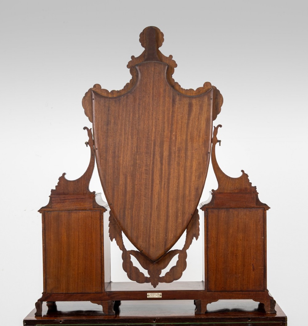 An Edwardian mahogany tabletop toilet mirror with a central shield-shaped swing glass flanked by two small painted cabinet pedestals. View IV
