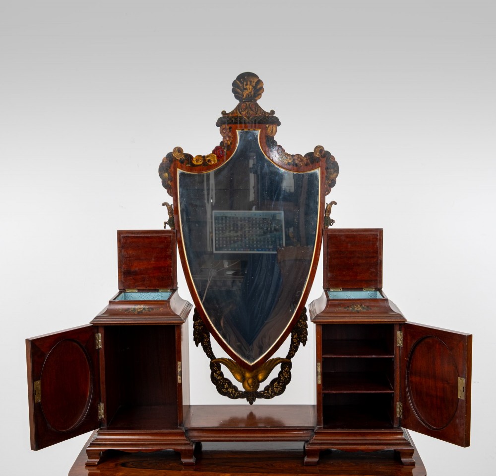 An Edwardian mahogany tabletop toilet mirror with a central shield-shaped swing glass flanked by two small painted cabinet pedestals. View VI