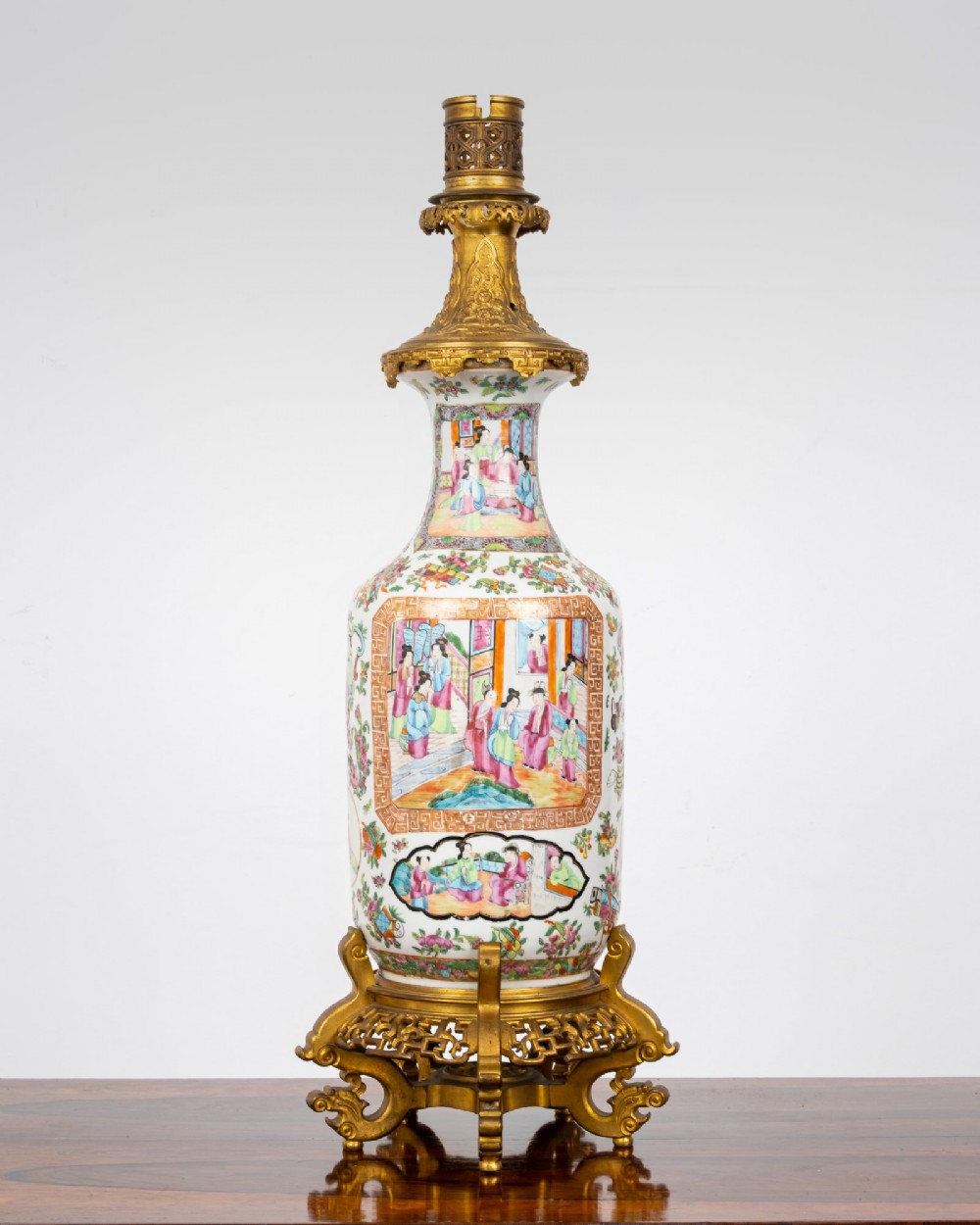 A nineteenth-century Rose Medallion porcelain vase mounted as a table lamp with an ornate gilt bronze base and collar.