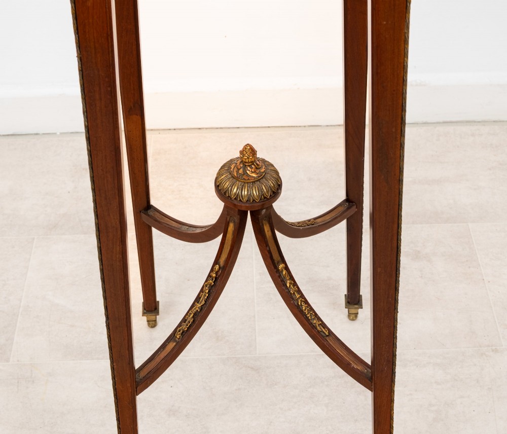 A tall French mahogany side table featuring a square rouge marble top with a pierced brass gallery, gilt-bronze frieze reliefs, and slender tapered legs connected by a curved stretcher. View V