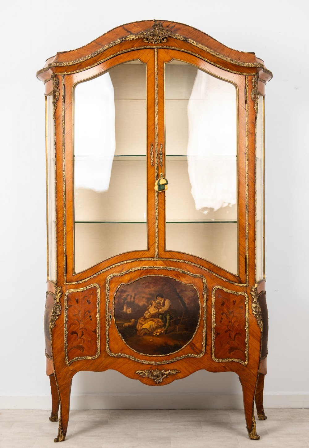 An antique French Louis XV style kingwood vitrine cabinet featuring glass doors, gilded ormolu mounts, and a hand-painted Vernis Martin panel at the base. View II