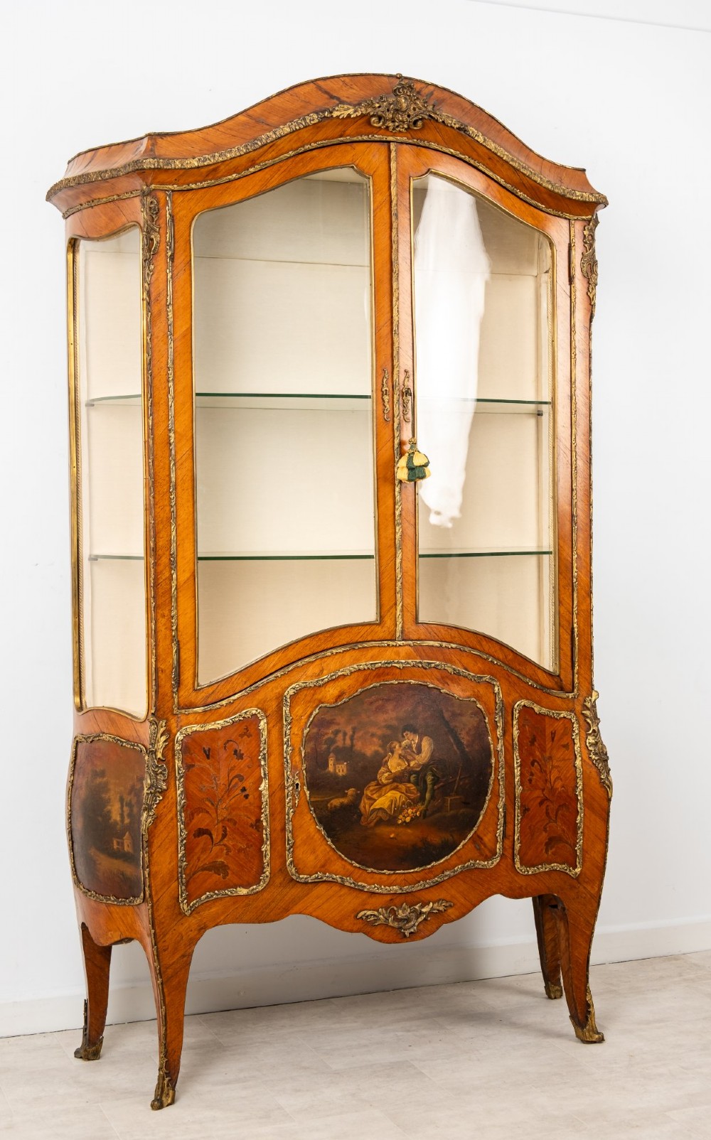 An antique French Louis XV style kingwood vitrine cabinet featuring glass doors, gilded ormolu mounts, and a hand-painted Vernis Martin panel at the base. View III
