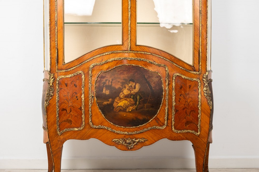 An antique French Louis XV style kingwood vitrine cabinet featuring glass doors, gilded ormolu mounts, and a hand-painted Vernis Martin panel at the base. View IV