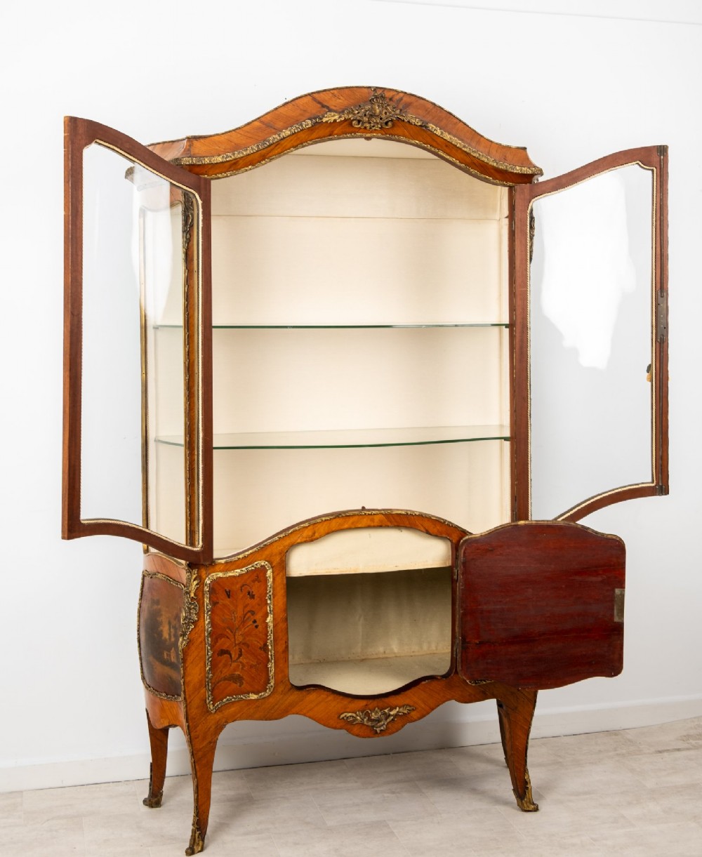 An antique French Louis XV style kingwood vitrine cabinet featuring glass doors, gilded ormolu mounts, and a hand-painted Vernis Martin panel at the base. View VI