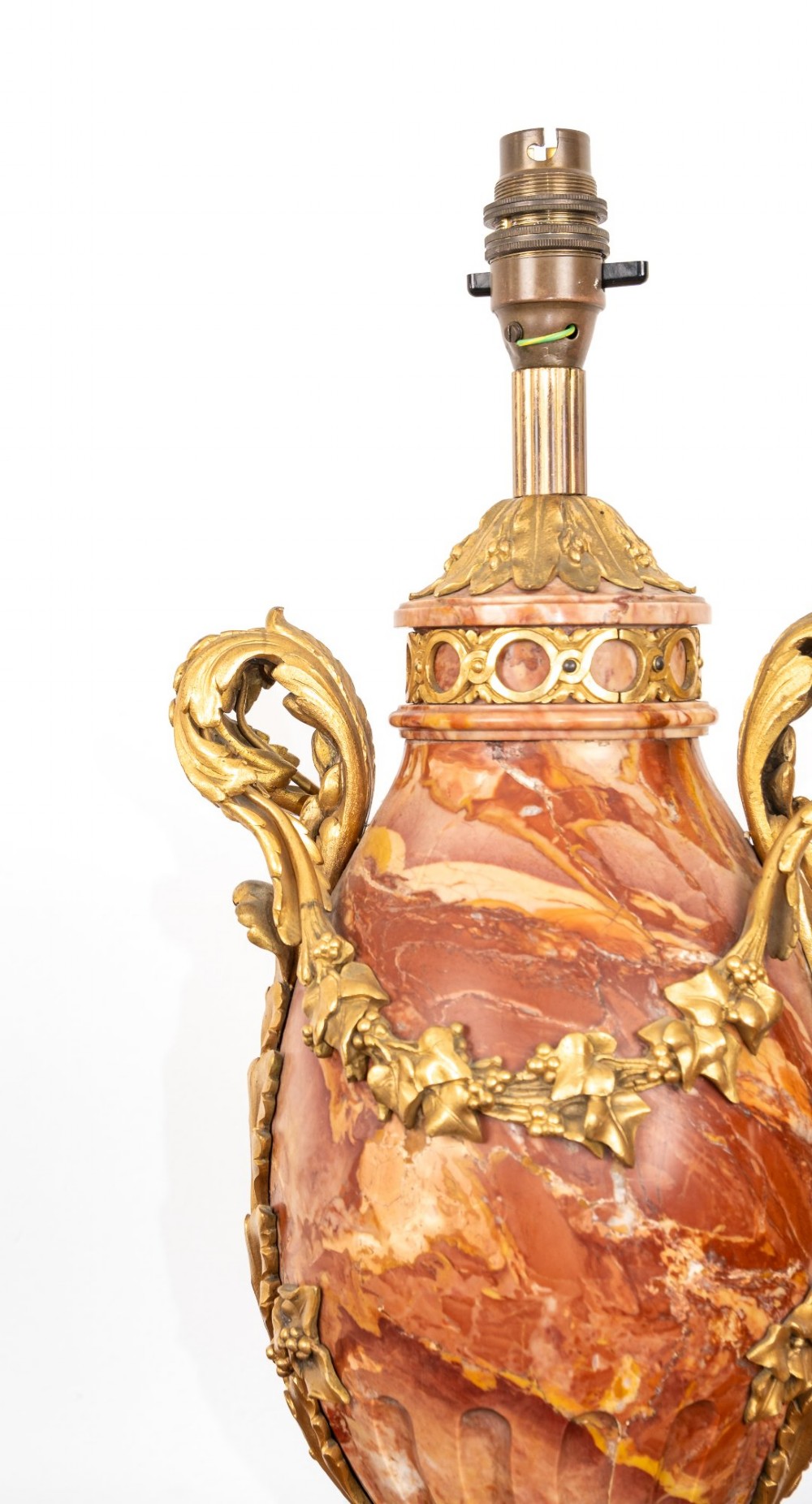 A pair of late nineteenth-century French urn-form table lamps crafted from veined red marble with gilt bronze scroll handles and floral garlands. View VI