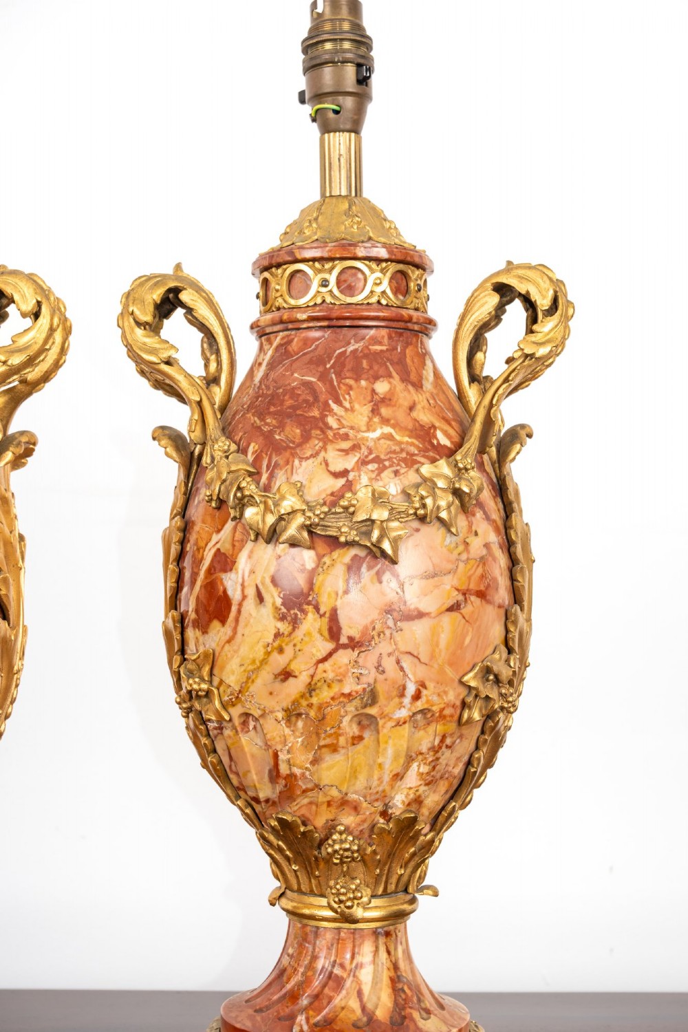 A pair of late nineteenth-century French urn-form table lamps crafted from veined red marble with gilt bronze scroll handles and floral garlands. View VIII